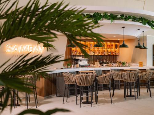 a bar in a restaurant with chairs and a counter at Grand Sirenis Riviera Maya Resort & Spa All Inclusive in Akumal