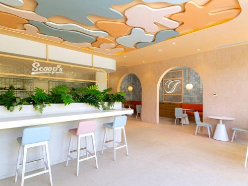a restaurant with stools and a bar in a cafeteria at Grand Sirenis Riviera Maya Resort & Spa All Inclusive in Akumal