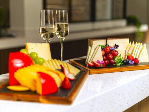 a table with two plates of cheese and wine glasses at Grand Sirenis Riviera Maya Resort & Spa All Inclusive in Akumal