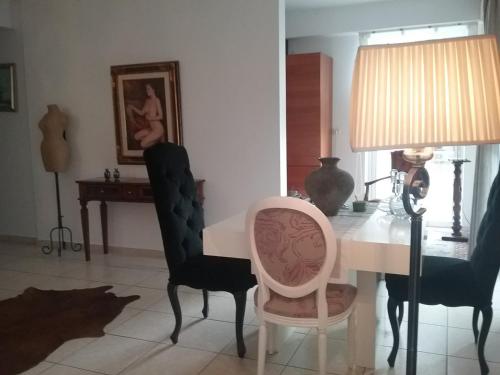a dining room with a white table and chairs at Luxury Apartment with Sea View! in Patra