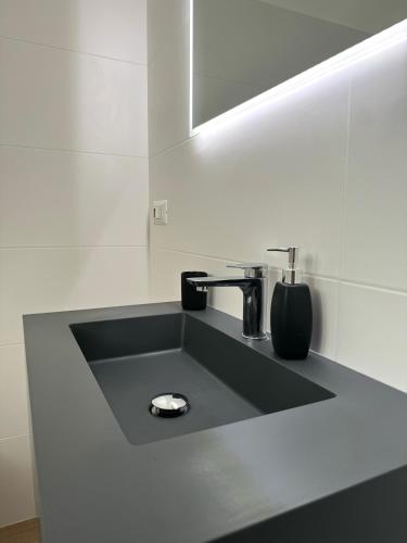 a bathroom with a sink and a mirror at Dimora 21 in Ruffano