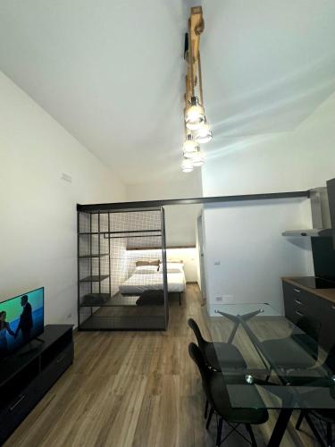a room with a bedroom with a bed and a television at Dimora 21 in Ruffano