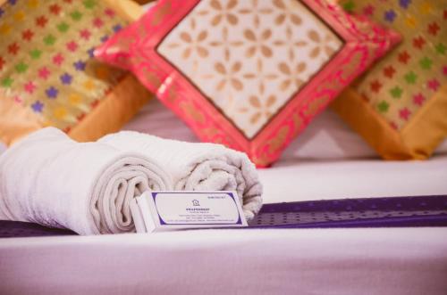 a pile of towels on a bed with other blankets at Hotel Sodizang Retreat in Pelling