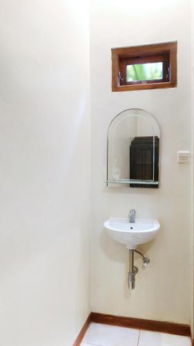 a bathroom with a sink and a mirror at Dapur Ethnic Homestay in Bantul