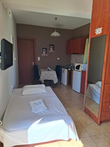 a living room with two beds and a kitchen at Belleza Villa in Lixouri
