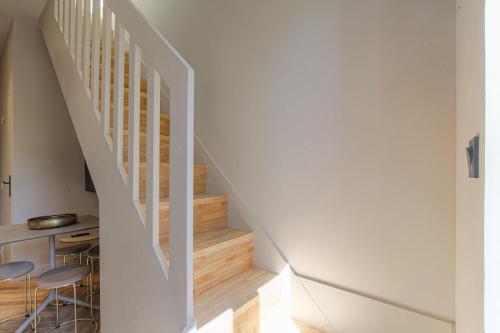a staircase with two chairs and a table in a house at Appartement moderne et chaleureux, Ecully in Écully