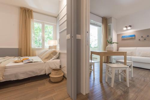 En eller flere senge i et værelse på Hotel Villa Tosi