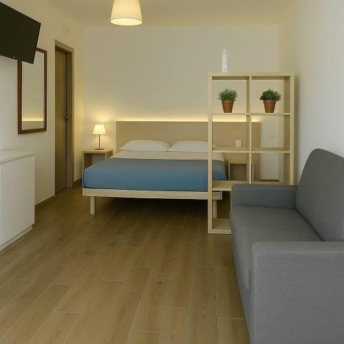 a bedroom with a bed and a couch at Residence Nonna Mariuccia in Mazara del Vallo