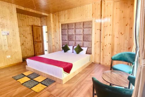 a bedroom with a bed and a table and chairs at Dahar Retreat - A Boutique Homestay in Kotla