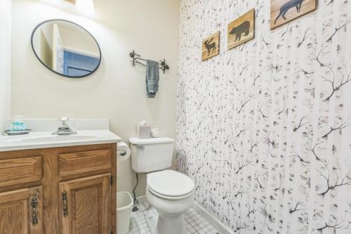 a bathroom with a toilet and a sink and a mirror at Uncas 16N - Spacious & Scenic Townhome in North Creek