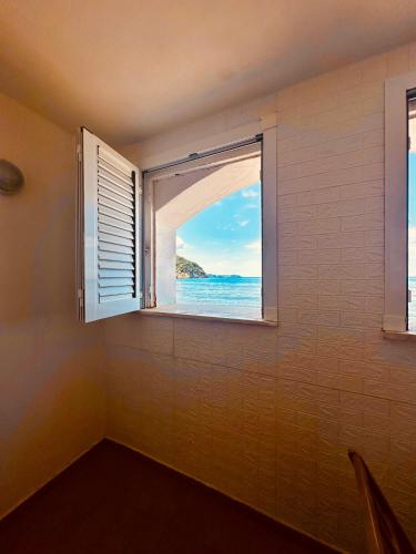 a window in a room with a view of the ocean at Lido Di Procida Guest House in Procida
