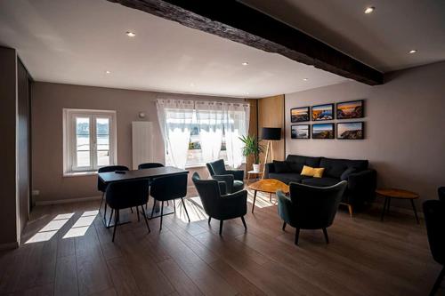 a living room with a couch and a table and chairs at Hostellerie De La Mer in Crozon