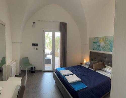 a bedroom with a large blue bed in a room at Dear Mary, B&B romantico vicino Lecce nel cuore del Salento in San Cesario di Lecce