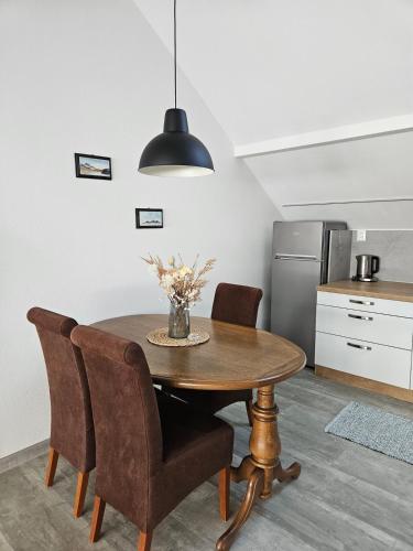 a kitchen with a table and chairs and a refrigerator at Apartmán na skok od kúpeľov in Partizánske