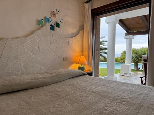 a bedroom with a bed and a view of the ocean at Villa Astra fronte mare - Porto Cervo in Porto Cervo
