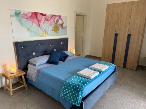 a blue bed in a room with a table at Dear Mary, B&B romantico vicino Lecce nel cuore del Salento in San Cesario di Lecce