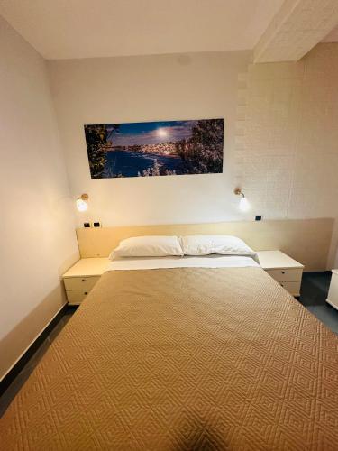 a bedroom with a large bed with two night stands at Lido Di Procida Guest House in Procida