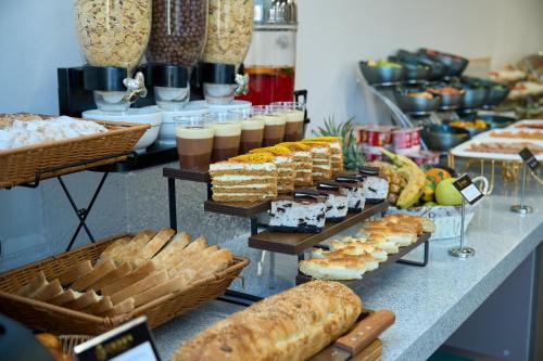 a buffet with various types of bread and pastries at Crown Hotel in Bishkek