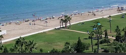 a group of people on a beach with the ocean at Costa Marina III - 1ª línea de playa in El Borseral