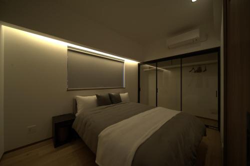 a bedroom with a large bed in a room at LAGUNA OKINAWA Beachfront YAKA in Kin