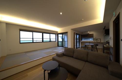 a living room with a couch and a table at LAGUNA OKINAWA Beachfront YAKA in Kin