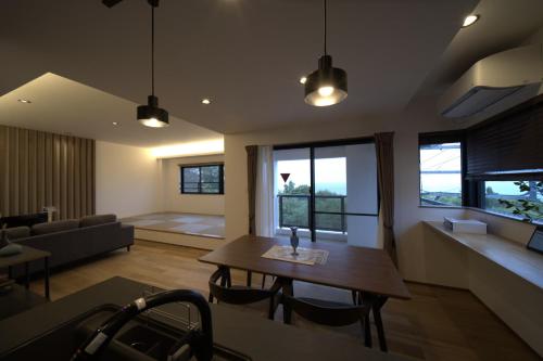 a living room with a table and a couch at LAGUNA OKINAWA Beachfront YAKA in Kin