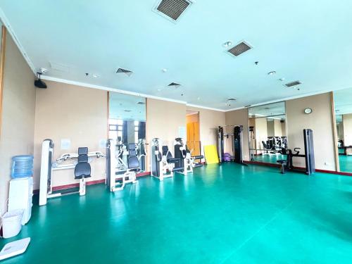 a gym with machines and chairs in a room at Holiday Inn Temple Of Heaven Beijing by IHG in Beijing