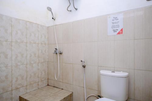 a bathroom with a shower and a toilet in it at RedDoorz Syariah at Omah Pathok Malioboro in Yogyakarta