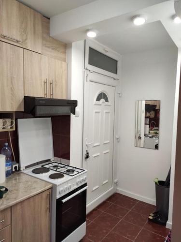 a kitchen with a stove and a white door at KS Studio 2 in Belgrade