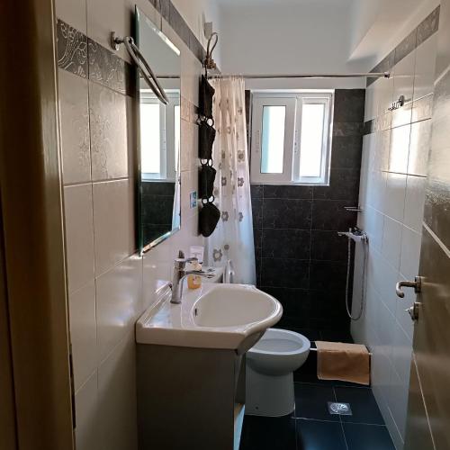 a bathroom with a sink and a toilet at Βlue Horizon Lixouri in Lixouri