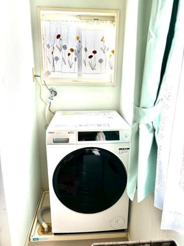 a microwave sitting in a room with a window at Stay Chacha 城下町茶茶2F in Marugame