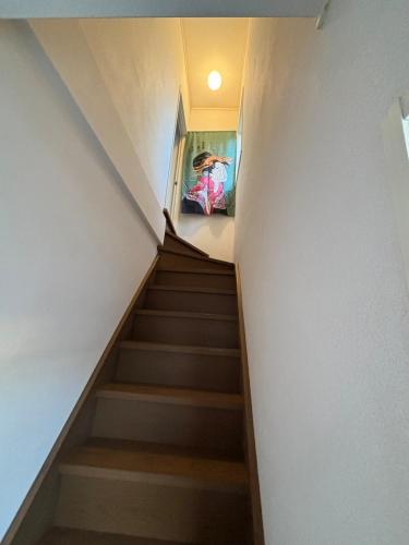 a staircase leading up to the basement of a house at Stay Chacha 城下町茶茶2F in Marugame