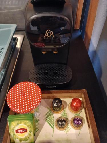 a coffee maker with four donuts in a box at Fare TANGARA in Arue