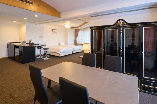 a hotel room with a table and a bed at Resol no Mori in Nagara