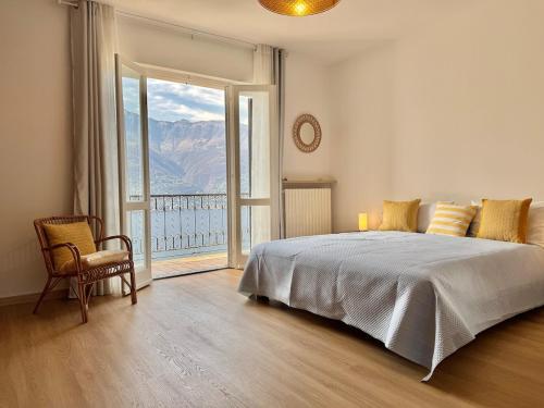 a bedroom with a bed and a large window at Villa Miralago in Tronzano Lago Maggiore