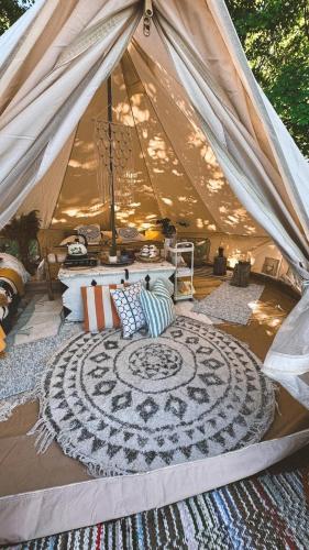 a tent with a rug in the middle of a room at Mereääre Glamping ja Rannamaja in Liimala