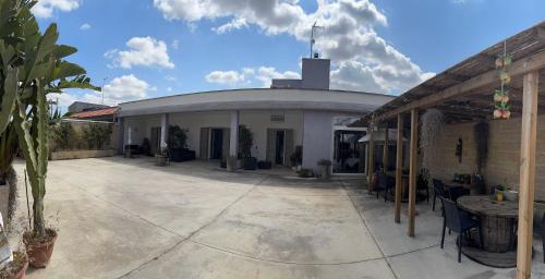 a building with a round roof with a patio at Dear Mary, B&B romantico vicino Lecce nel cuore del Salento in San Cesario di Lecce