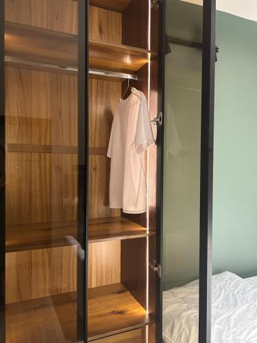 a wardrobe with a white shirt hanging in a bedroom at Central Cozy Minimalist Studio apartment in Maroko