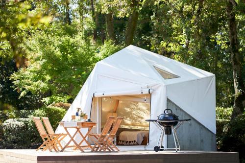a white tent with chairs and a grill at Resol no Mori in Nagara