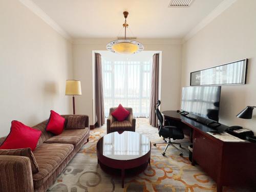 a living room with a couch and a piano at Holiday Inn Temple Of Heaven Beijing by IHG in Beijing