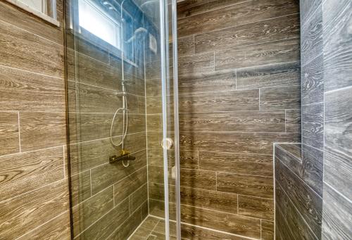 a bathroom with a shower with a glass door at Grisverde Suites in Istanbul