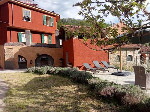 a group of chairs sitting in front of a building at Camerana La Casa Rossa in Camerana 