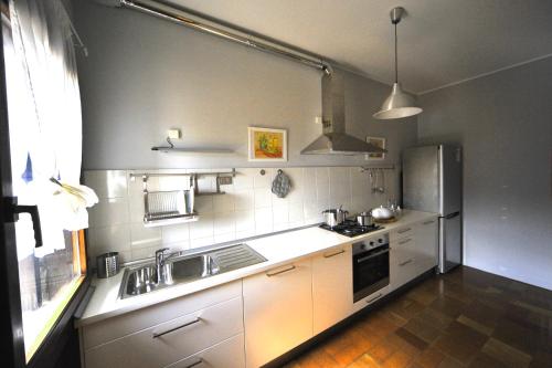 a kitchen with a sink and a refrigerator at Casa Verde Conero in Castelfidardo