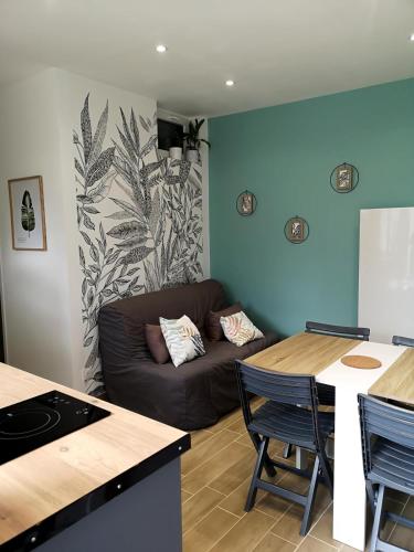 a living room with a couch and a table at Dépendance avec terrasse, Disneyland Paris in Esbly