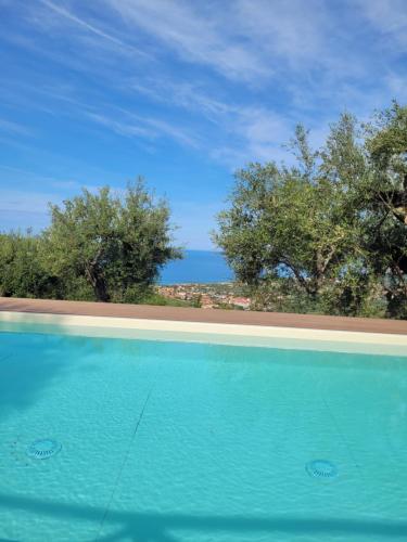 a swimming pool with a view of the ocean at Casolare Cento Ulivi Luxury & Charme - Villa exclusive use in Ascea
