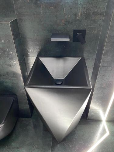 a silver object on the floor in a room at Luna Apartments A in Suceava