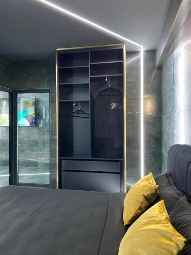 a bedroom with a bed with a yellow pillow on it at Luna Apartments A in Suceava