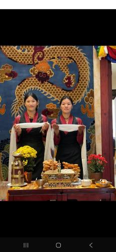 two women standing in front of a table with food at KAMALASHI BOUTIQUE Inn in Kathmandu