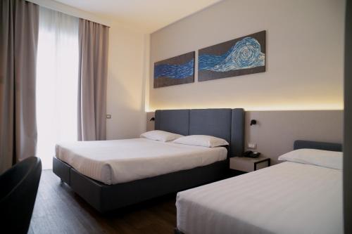 Postel nebo postele na pokoji v ubytování Sea Lion Hotel