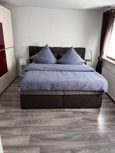a bedroom with a bed and a wooden floor at Inselblüte 2 in Werder